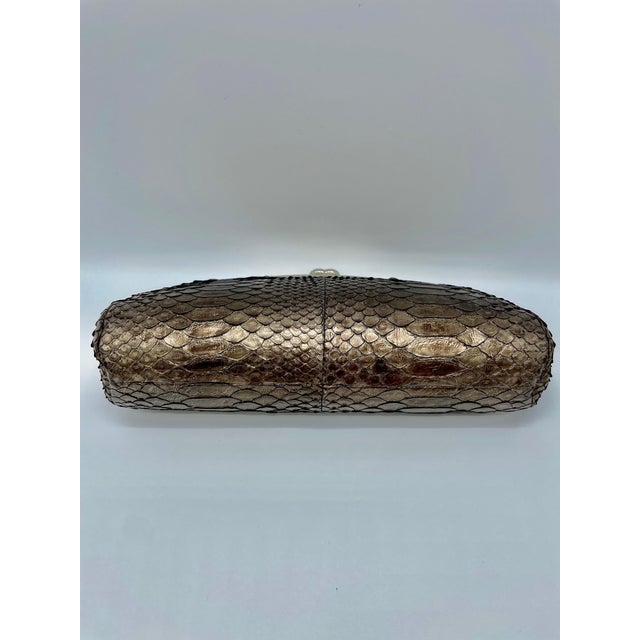 Python clutch by Chanel. The color silver is reflected by the sun and generates distinct hues. This gorgeous bag is a one-...