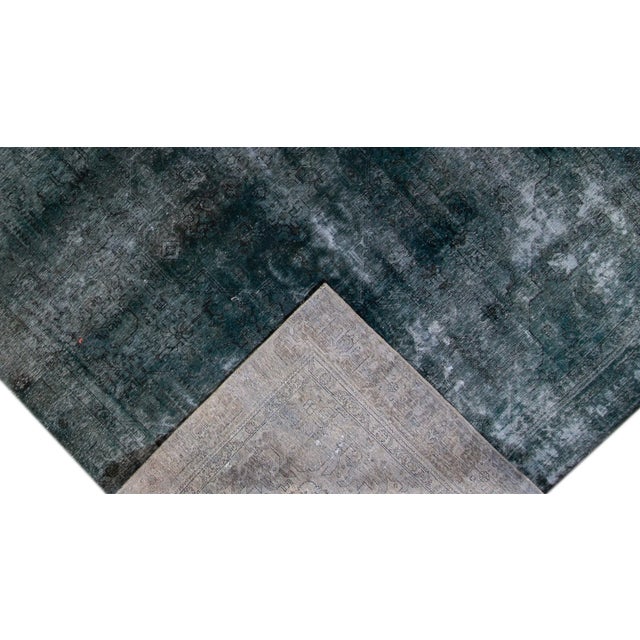 Beautiful hand-knotted vintage wool rug with a navy-blue field. This distressed rug has light blue accents featuring an...