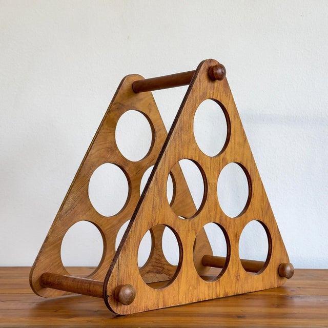 Has a nice medium wood variegated veneer. Has 6 holders for bottles. In good, vintage condition. A few chips to veneer, on...