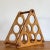 Has a nice medium wood variegated veneer. Has 6 holders for bottles. In good, vintage condition. A few chips to veneer, on...