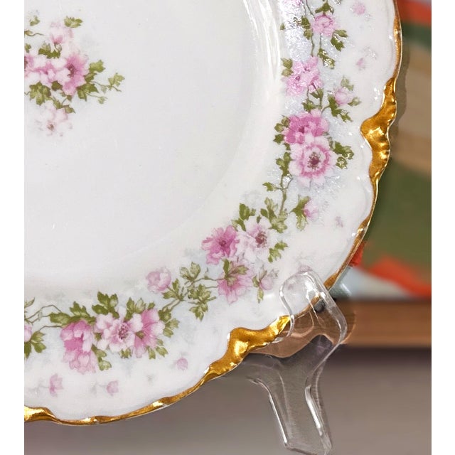 Antique Elite Works French Limoges porcelain plate crafted in France. It features a heavily gilded scalloped border,...