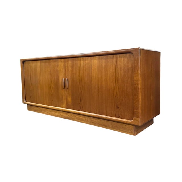 Mid-Century Modern credenza from Denmark by Dyrlund. Featuring tambour doors that open to reveal 5 central drawers and...