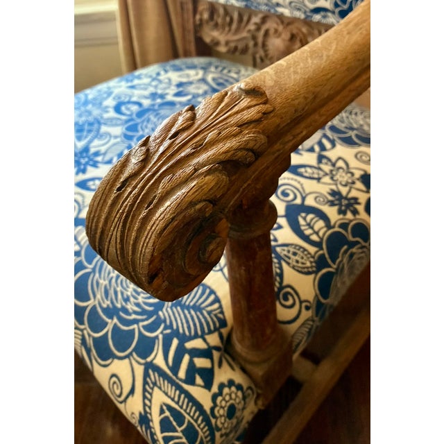 A commanding antique Spanish carved armchair of exceptional character. The hand-carved frame — acanthus leaf terminals on...