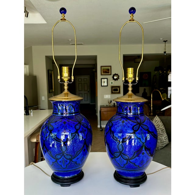 Pair of mid-20th-century table lamps crafted from authentic, hand-painted Safi Moroccan terracotta jars. Exhibiting a...