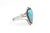 A striking Southwestern cuff bracelet featuring a vivid blue, teardrop-shaped turquoise cabochon in a darkened silver...