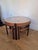 A striking 1960s Nathan Trinity Model 5614 teak coffee table with three nesting tables, combining sculptural mid-century...