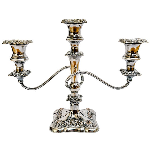 A regal pair of English silverplated candelabras dating to the early 20th Century by Baker Ellis Silver Co. Featuring the...