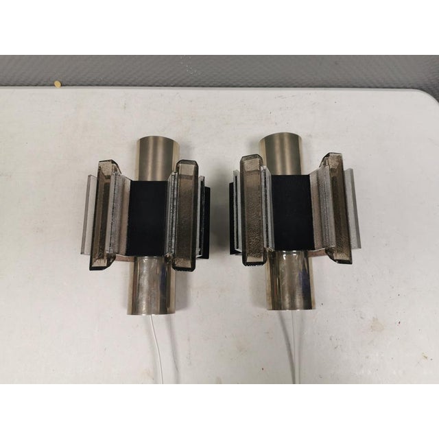 A set of very rare Claus Bolby wall lamps made by Cebo. with metal socket housings, shades of grey and smoke-coloured and...