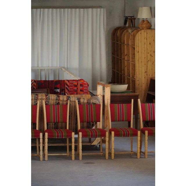 A beautiful set of six sculptural dining chairs in solid oak by Henning (Henry) Kjærnulf, Denmark, 1960s. The chairs carry...