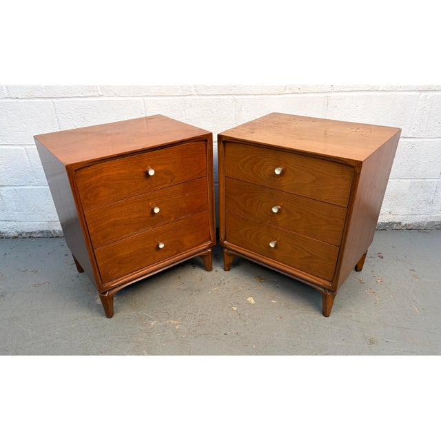 Handsome pair of mid-century modern nightstands crafted from richly grained walnut. Featuring beautifully constructed...
