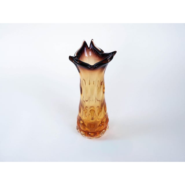 The vase was made in the 1960s in Italy. A vase from the 1960s/1970s, made of artistic glass in shades of amber and plum,...