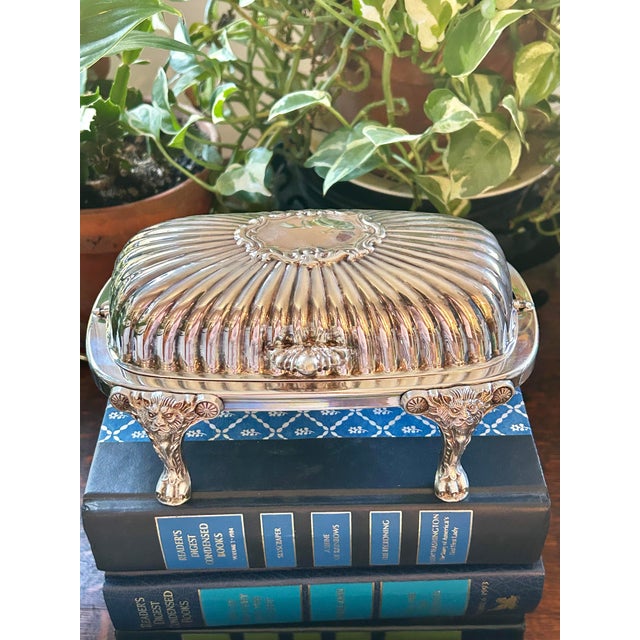 From F B Rogers Silver Co., this silver plate roll top butter dish has all of the features. The style would be Baroque and...