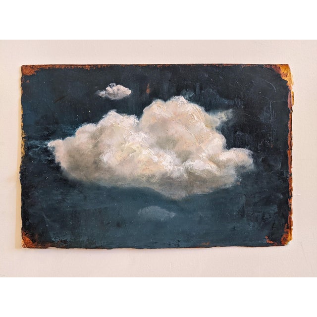 This oil on paper artwork features a soft, billowing cloud set against a deep blue background, evoking a sense of...