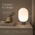 This cordless table lamp features a soft, capsule-inspired silhouette that brings a warm and cozy atmosphere to any space....