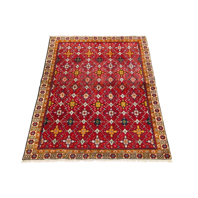 This gorgeous, vintage hand-knotted Shiraz wool rug is distinguished by its vibrant red field. The piece features diverse...