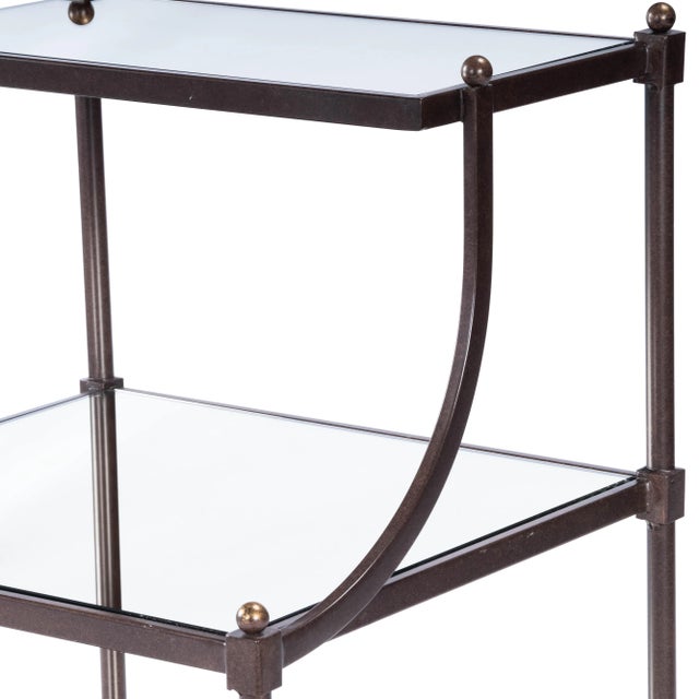 Transitional-styled table with a metal frame construction. Frame is finished in a light bronze tone with antiqued mirror...