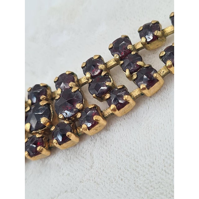 A unique vintage necklace crafted from natural faceted garnets in a deep, elegant dark burgundy hue. The jewelry...