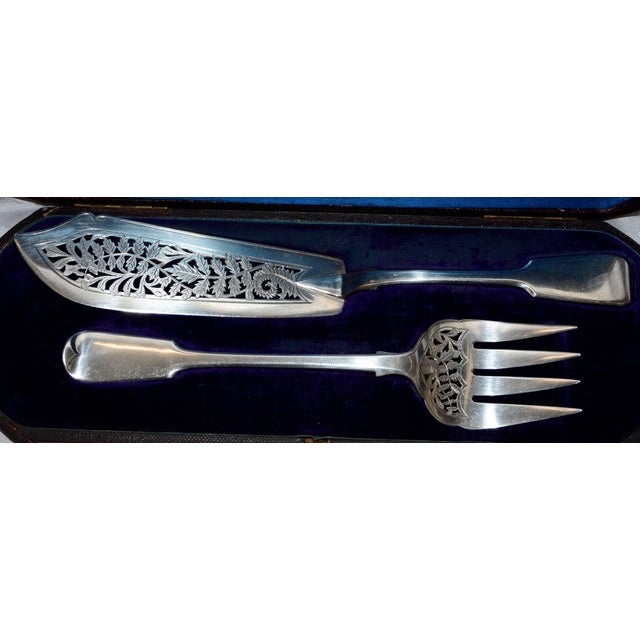 The engraving style on the cut-out of this lovely sterling silver fish set by the George Angell Co. of London are...