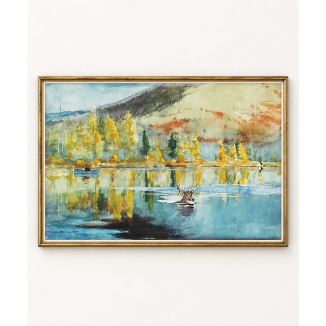 This vintage fall landscape art print with deer by Winslow Homer captures a luminous October scene reflected across...