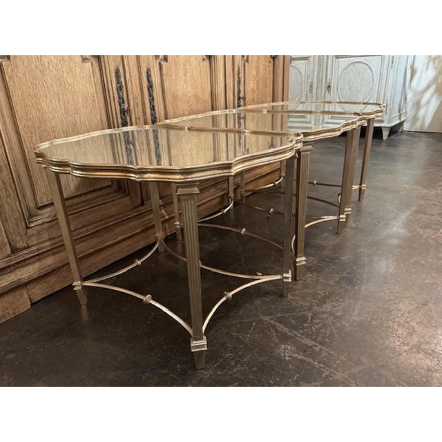 The Vintage Italian Silver Leaf 3 Section Coffee Table with a Mirrored Top is a stylish and elegant piece of furniture...