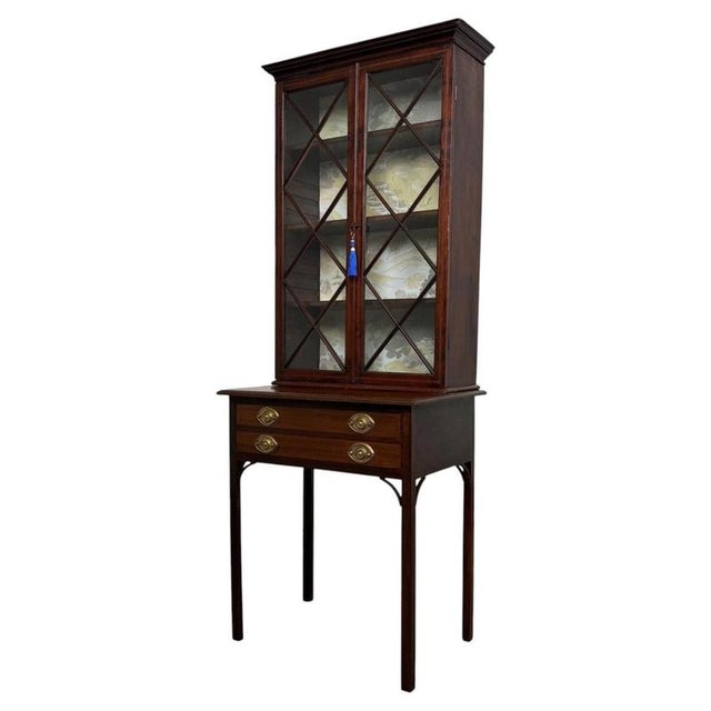 A superb late 18th-century English Georgian display cabinet, finely constructed in mahogany and distinguished by elegant...