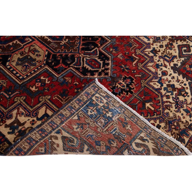 Beautiful vintage Persian Tabriz hand-knotted wool rug with a red color field. This piece has a blue frame and multicolor...