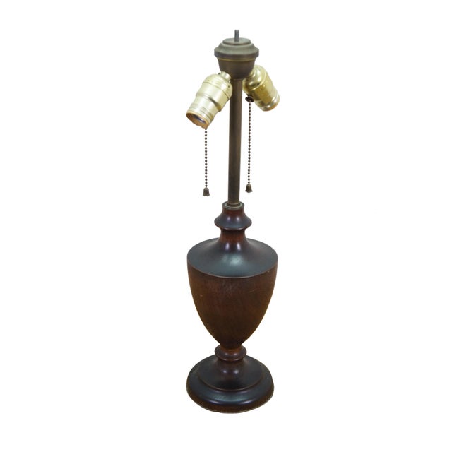 This vintage mid-century table lamp features an elegant urn-shaped central body crafted from dark turned walnut wood with...