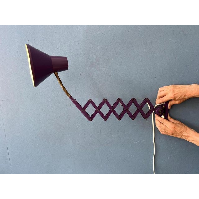 Purple mid century space age scissor wall lamp made out of metal. The lamp is extendable with the scissor mechanism. Also...