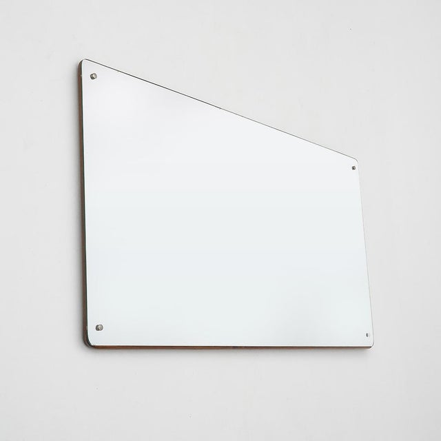 Essential and rigorously composed, this 1950s rectangular wall mirror reflects the restrained formal language of postwar...