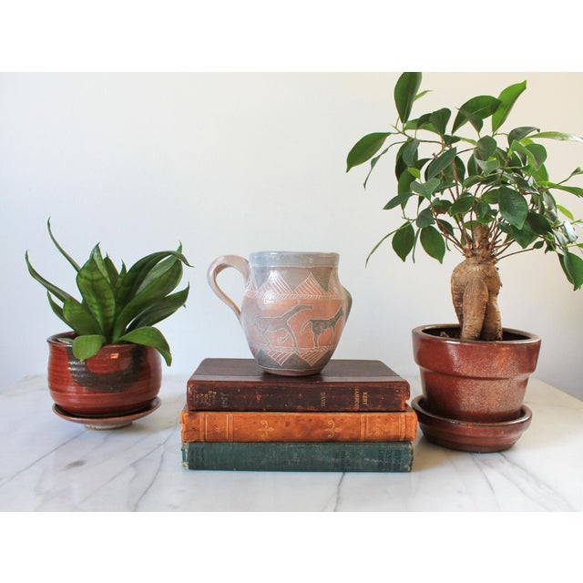 Vintage Southwestern Native American pottery mug features hand-painted and incised designs of horses, people and sea...