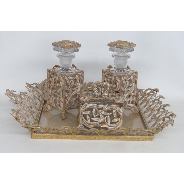This gorgeous 4pc Vanity Set is made of carved glass and gilded metal. This stunning Hollywood Regency set comes with 2...