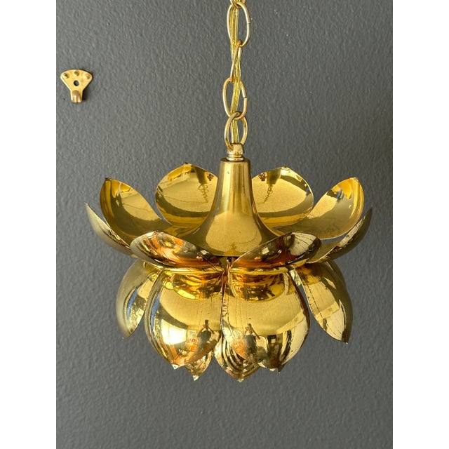Small brass lotus light fixture attributed to Feldman Lighting Co. Requires one up to 60watt bulb. Chain is 50" long and...