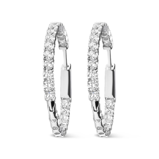 Discover the enchanting radiance of our 14K white gold hoop earrings, where sophistication meets modern luxury in each...