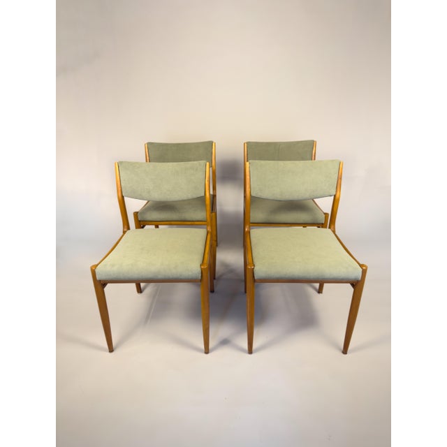 This vintage set of four Scandinavian dining chairs features solid beech wood frames and newly remade green upholstered...