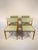 This vintage set of four Scandinavian dining chairs features solid beech wood frames and newly remade green upholstered...