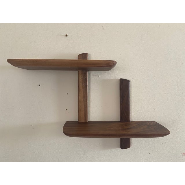 Handmade solid walnut midcentury modern wall shelf. Hangs by two hidden brackets. Rounded and beveled edge makes for a...