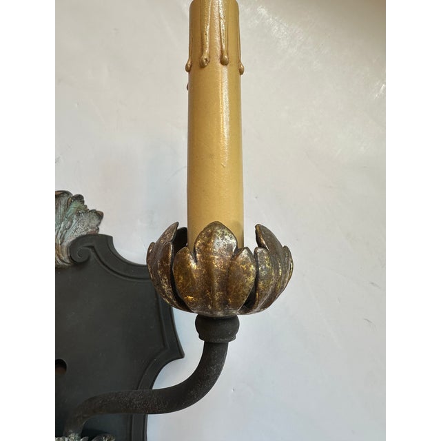 Pair of duel arm Regency style iron sconces with brass bobeches having wonderful vintage gilt and paint on some surfaces....