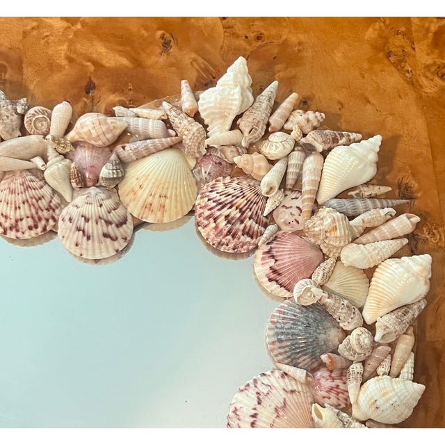 A charming vintage coastal accent piece, this heart-shaped mirror is entirely hand-framed with a mix of natural seashells...