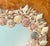 A charming vintage coastal accent piece, this heart-shaped mirror is entirely hand-framed with a mix of natural seashells...