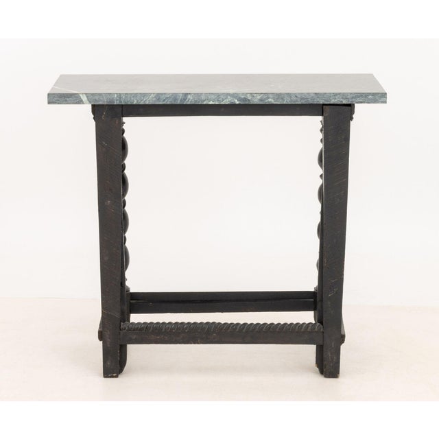Flemish Ebonized and Carved Wood Console Table, with associated green and black marble top above barley twist legs, carved...