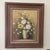 This is a still life painting of a flower bouquet that is framed and signed by the artist. The painting is done on a...