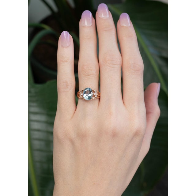 A serene 2ct oval aquamarine (10x7mm) glows with soft ocean-blue hues, accented by brilliant lab-created diamonds for...