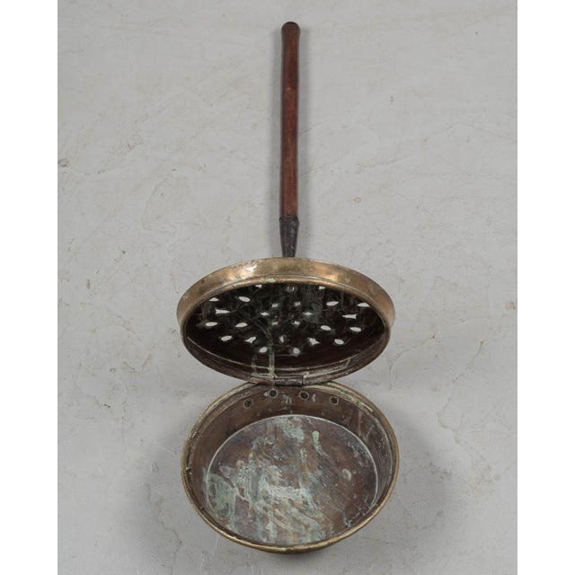 A collection of five French bassinoires, or bed warmers, ranging in age from the late 18th century to the mid 20th...