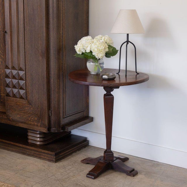 Lovely wood side table from France, 1940s. Thick circular top rests on a curved tapered base with four feet. Original...