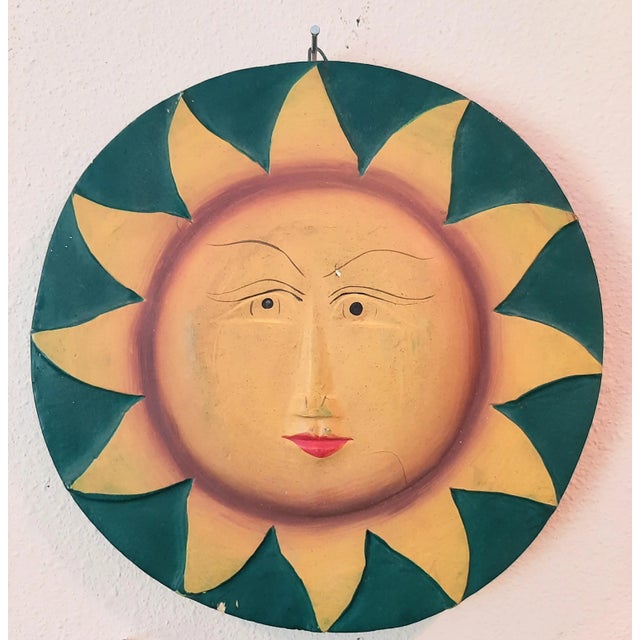 Double-sided vintage mexican folk art wall hanging plaque of the moon on one side and the sun on back. It hangs either...