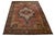 This oversized hand-knotted wool Sarouk Farahan rug features a red field, a dark blue frame, and multicolor accents,...