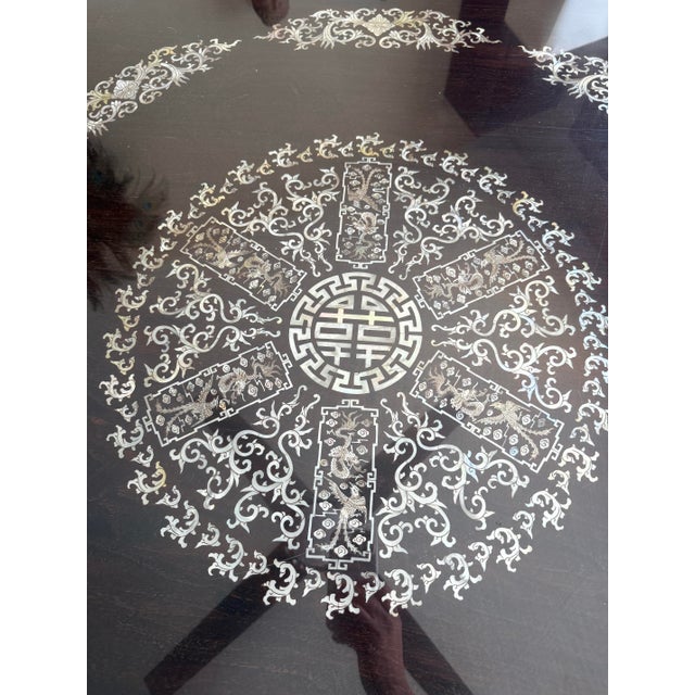 An extraordinary and one-of-a-kind Chinese banquet table and eight-chair ensemble showcasing exceptional craftsmanship and...