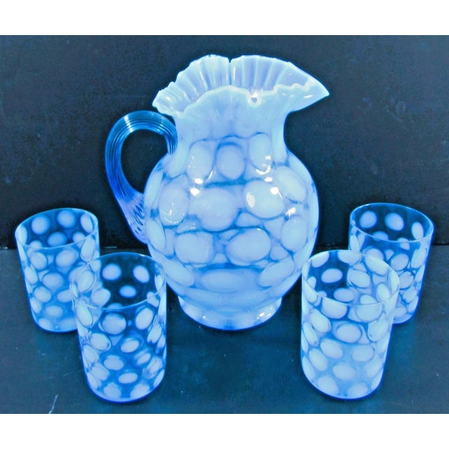 This Vintage Fenton Blue Opalescent Coin Spot Glass Pitcher and 4 Tumblers Set is a beautifully crafted piece of mid-...