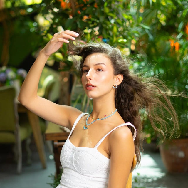 Bring mystical elegance and protective energy into your style with the Turquoise Beaded Chain Evil Eye Topaz Gold...