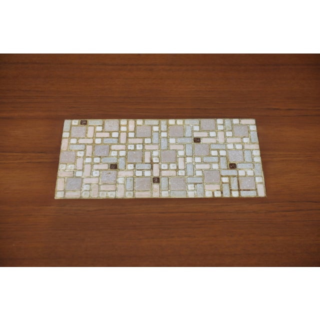 A Scandinavian coffee table from the 1960s, with a simple and balanced design. The rectangular top with softened corners...